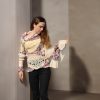 Elegant Burst expressive dual-texture knit with relaxed fit and playful sleeve contrast
