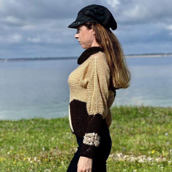 Elegant Contrast relaxed fit knit with cropped waist and long, mismatched sleeves for expressive style