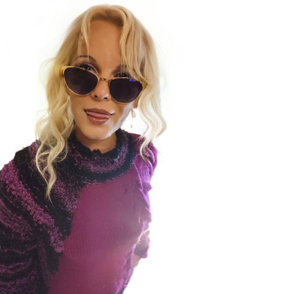 Designer sweater in deep plum with cape influence and sculptural accents.
