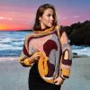 Plush Enigma featuring plush fabrics in layered colors of burgundy, brown, gray, pink, and orange.