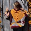 Plush Enigma combining bold stripes and gentle spirals in burgundy, pink, gray, and orange tones.